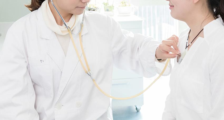 Nurse checking heart beat using stethoscope